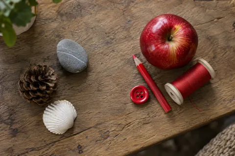 Red objects grouped together on a table