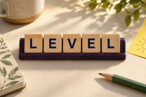 Five wooden letter tiles spelling LEVEL on a purple tray