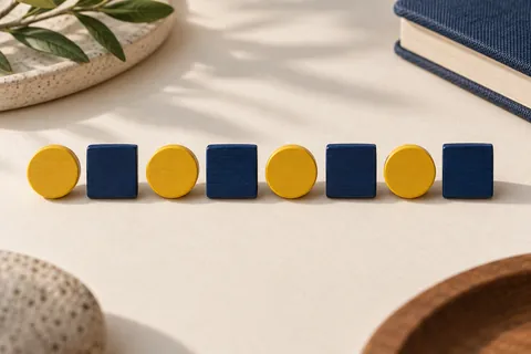 An alternating row of yellow wooden circles and navy squares